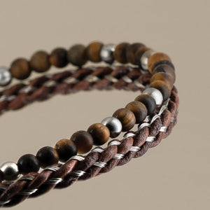 TMJ Marlowe tiger eye and braided leather wrap bracelet featuring polished tiger eye beads and woven leather strands.
