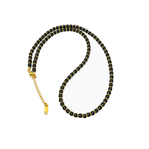 Onyx and gold hematite beaded necklace featuring classic round beads and a T.M.J brand clasp on a white background.
