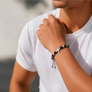 Sentinel Onyx beaded cross bracelet by T.M.J featuring black beaded stainless steel design with a cross charm.