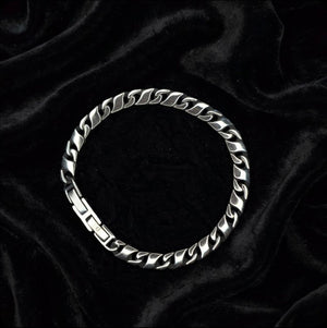 Titan Flat Cuban Curb Chain Bracelet in stainless steel, T.M.J. metal bracelet with flat Cuban links visible in the image.