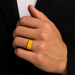 Men’s polished gold finish stainless steel dress ring on hand.