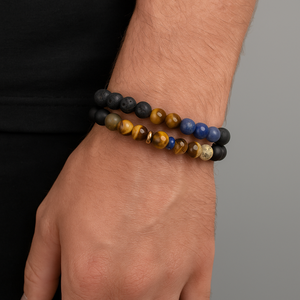 Wrap around multi stone beaded bracelet on wrist, featuring agate, hematite, tiger eye, lapis lazuli, jasper, lava beads, and rose gold Balinese bead.