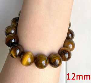 12mm brown Tiger Eye beaded bracelet with handcrafted Bali silver bead on wrist.