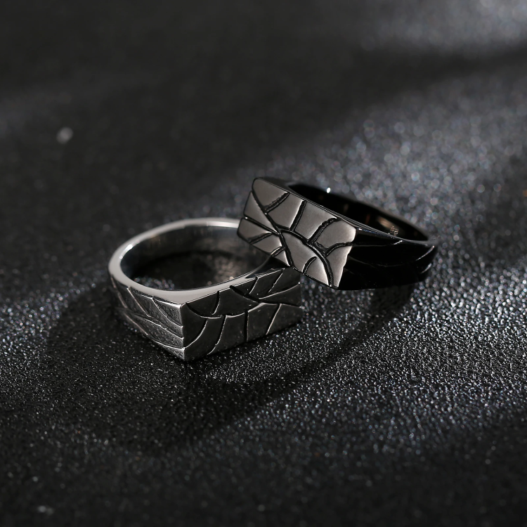 Men’s stainless steel ring with crazy pattern finish on dark background.