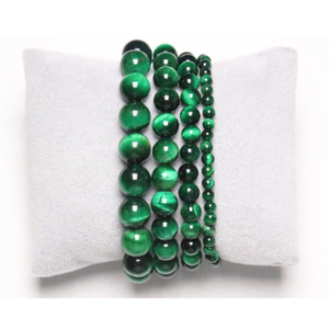 Green Tiger Eye bead bracelet with stainless steel spacer on cushion display.
