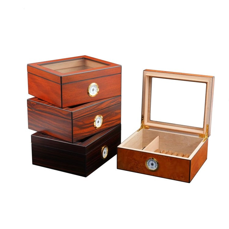Small wooden cigar humidor with glass top and gloss ebony finish, holds up to 25 cigars, features humidifier and analog hygrometer.