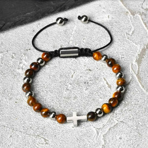 Sentinel Tiger Eye beaded cross bracelet by T.M.J featuring stainless steel beads and a detailed cross pendant.