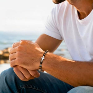 Sentinel Tiger Eye beaded cross bracelet by T.M.J featuring tiger eye beads and stainless steel accents, stylish and spiritual accessory.