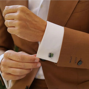 T.M.J engraved square cufflinks for men on white shirt cuff with brown suit jacket