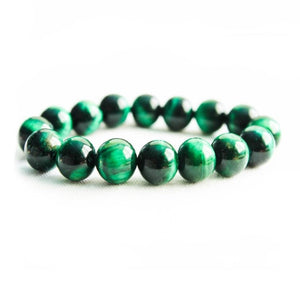 Handcrafted Green Tiger Eye bead bracelet with emerald hue and polished luster.
