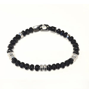 Black agate hexagonal bead bracelet by T.M.J featuring stainless steel accents, showcasing the detailed geometric beads.
