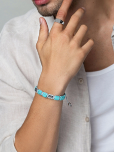 T.M.J Eye of Dharma Flatbead Collection bracelet featuring turquoise and silver beads on a beaded bracelet.