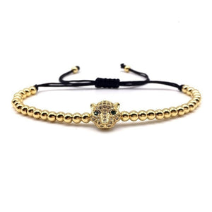 Gold beaded macrame bracelet with luxury CZ diamond Puma charm by T.M.J, stylish bead bracelet accessory.