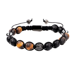 Beaded macrame bracelet featuring natural onyx and tiger eye stones, crafted by T.M.J with matte finish and intricate knotting.