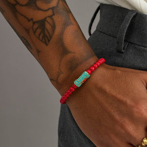Red chalcedony jasper bead bracelet by T.M.J featuring 6mm round beads on a stretch cord, styled with a love-themed design.