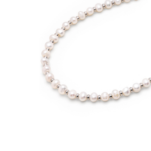 Mini beaded necklace by T.M.J with pearls and stainless steel spacer beads, featuring a delicate 45cm design.