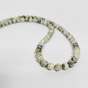 Peruvian turquoise and sterling silver beaded necklace by T.M.J, featuring vibrant turquoise beads and silver accents.