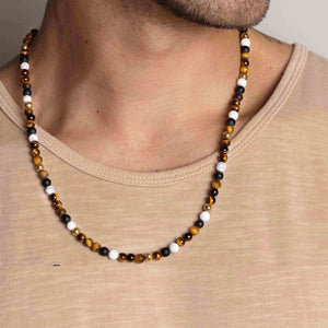 Beaded necklace featuring brown tiger eye, howlite, and onyx beads, crafted by T.M.J, showcasing natural stone jewelry.