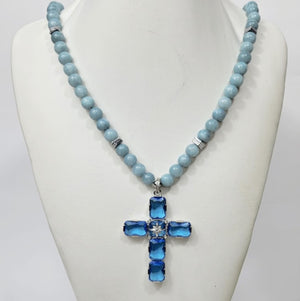 Large silver cross pendant with Austrian crystals on aquamarine beaded necklace by T.M.J, featuring intricate crystal detailing.