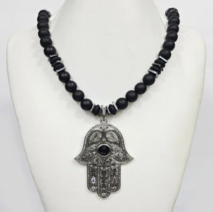 Large silver Hand of Hemsa pendant on T.M.J beaded necklace with Austrian crystals and matte onyx beads.