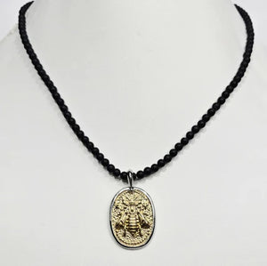 Black Onyx beaded necklace with silver and gold honey bee pendant, featuring elegant jewelry craftsmanship and detailed pendant design.
