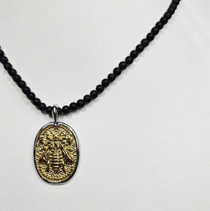 Black Onyx beaded necklace with silver and gold honey bee pendant, featuring elegant pendant details and beaded chain.