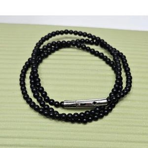 Black Onyx beaded necklace with silver and gold honey bee pendant, featuring elegant jewelry design by T.M.J.