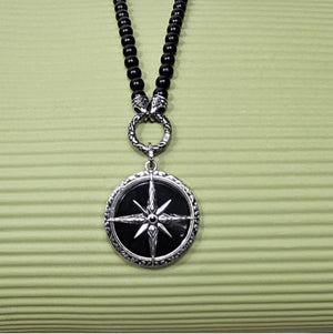 Black Onyx beaded necklace with silver and Onyx North Star pendant, featuring polished beads and a star-shaped pendant.
