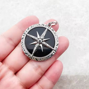 Black Onyx beaded necklace with silver and Onyx North Star pendant, featuring glossy black beads and a silver star-shaped charm.