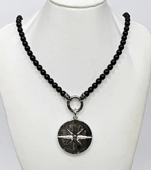 Black Onyx beaded necklace with silver and Onyx North Star pendant, featuring a detailed pendant design on a beaded chain.
