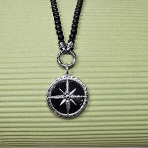 Black Onyx beaded necklace with silver and Onyx North Star pendant, featuring a close-up of the pendant and beaded chain.