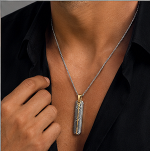 Damascus steel slim dog tag pendant with gold accent, attached to a chain, featuring a sleek, modern design by T.M.J.