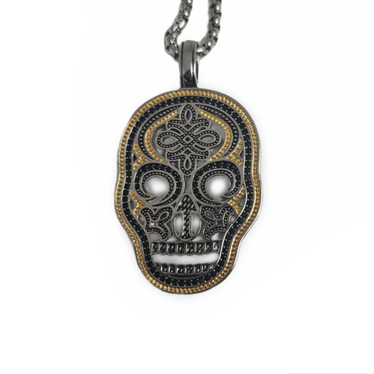 Gold and silver pave skull pendant on a chain, featuring detailed skull design, by T.M.J.