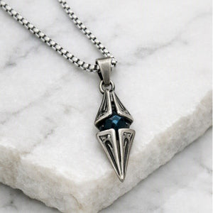 T.M.J Vesper antique steel spike pendant with blue CZ accent, featuring a bold, edgy design and detailed craftsmanship.