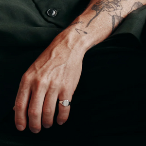 Heritage men's sterling silver oval signet ring, T.M.J brand, showcasing a polished silver ring with engraved oval face.