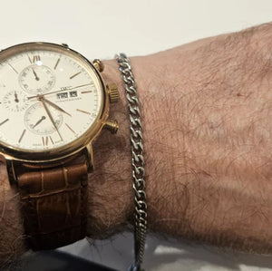 Stainless steel and gold-plated curb link bracelet by T.M.J, 5mm width, 19.5cm length, featuring polished gold accents.