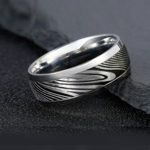 8mm etched Damascus steel and stainless steel ring by T.M.J, featuring a detailed pattern and sleek silver finish.