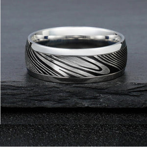 8mm etched Damascus steel and stainless steel ring by T.M.J, showcasing intricate patterns on a sleek silver band.