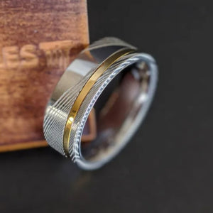 Helios 1 men's Damascus steel and gold inlay stainless steel ring by T.M.J, showcasing intricate design and craftsmanship.