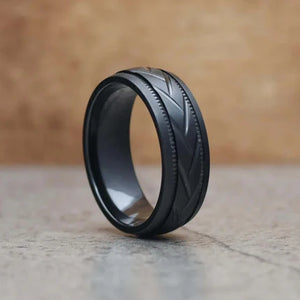 Black zirconium patterned men's stainless steel ring by T.M.J with intricate design and polished finish.