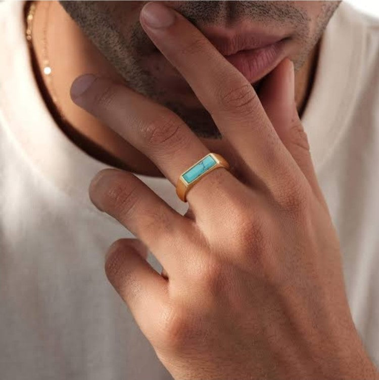 T.M.J stainless steel signet ring with gold plating and turquoise inlay, featuring a bold, stylish design.