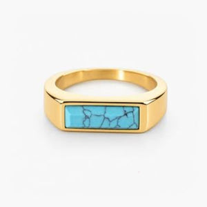 T.M.J stainless steel signet ring with gold plating and turquoise inlay, featuring a sleek, polished design and detailed craftsmanship.