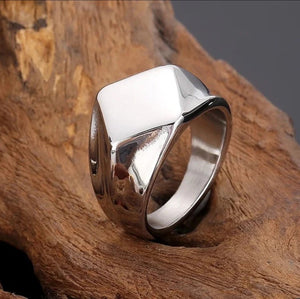 Men’s stainless steel square face ring by T.M.J in polished silver or gold, showcasing a modern, bold silhouette and sleek design.