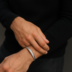 Sterling silver bangle with chevron design, brushed rhodium finish or 18K gold plating, by T.M.J, showcasing elegant jewelry craftsmanship.