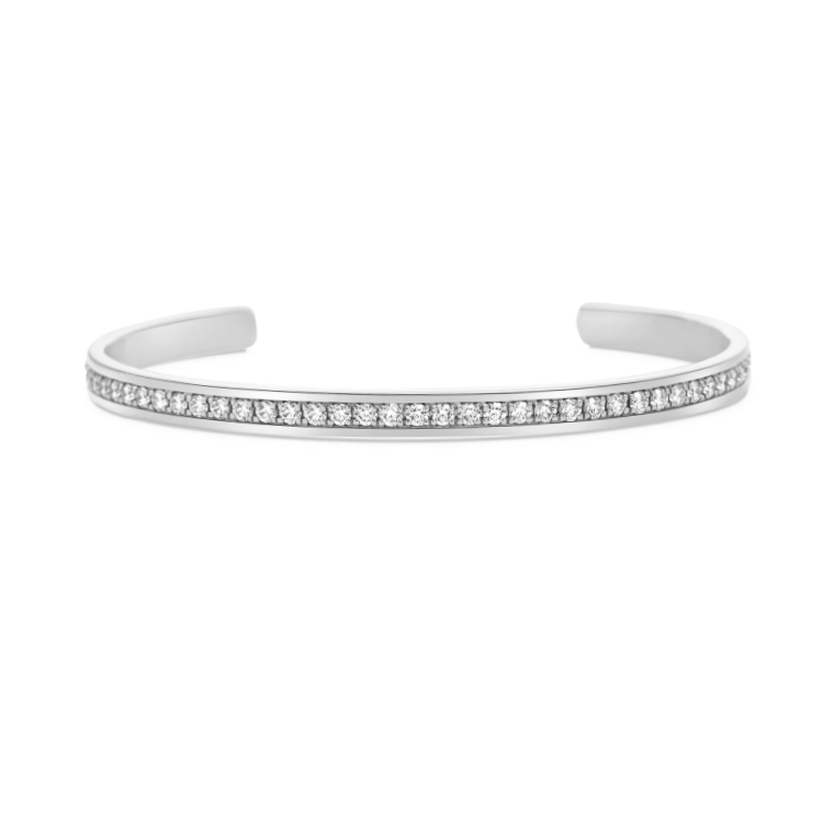 Sterling silver cuff bracelet with white sapphires from T.M.J, showcasing a sleek design with sparkling gemstones.