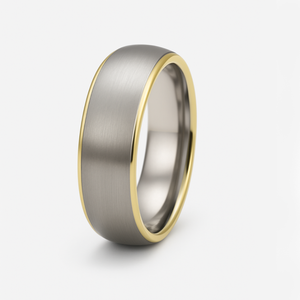 Titanium ring with gold-edged detail and satin finish top from T.M.J, showcasing a sleek, modern design and polished surface.