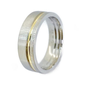 Titanium satin finish ring with gold inlay, 7mm wide, by T.M.J, showcasing sleek design and metallic detailing.