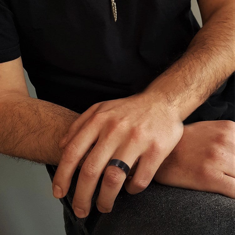 T.M.J Tungsten Rings "The Abyss" tungsten carbide ring with a sleek, polished finish and subtle dark accents for modern style.