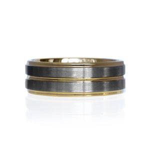 T.M.J tungsten ring with yellow gold satin finish top and polished gold edges, showcasing a sleek, modern design.