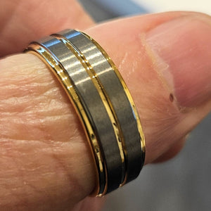 T.M.J tungsten ring with yellow gold satin finish top and polished gold edges, showcasing a stylish men's tungsten carbide ring.